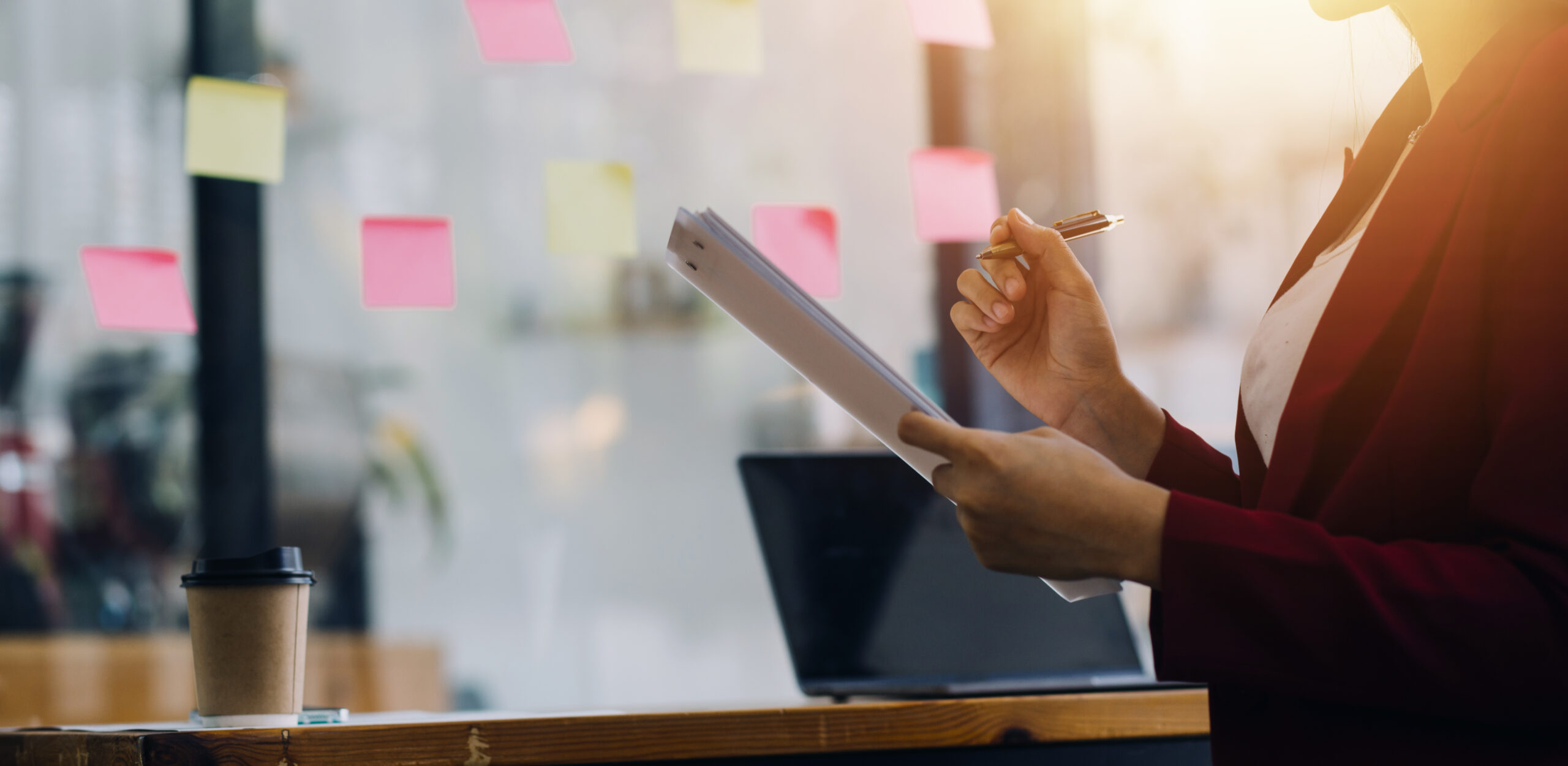 Person that is holding a piece of paper and pencil. ADAPT Project and Portfolio Manager action shot.